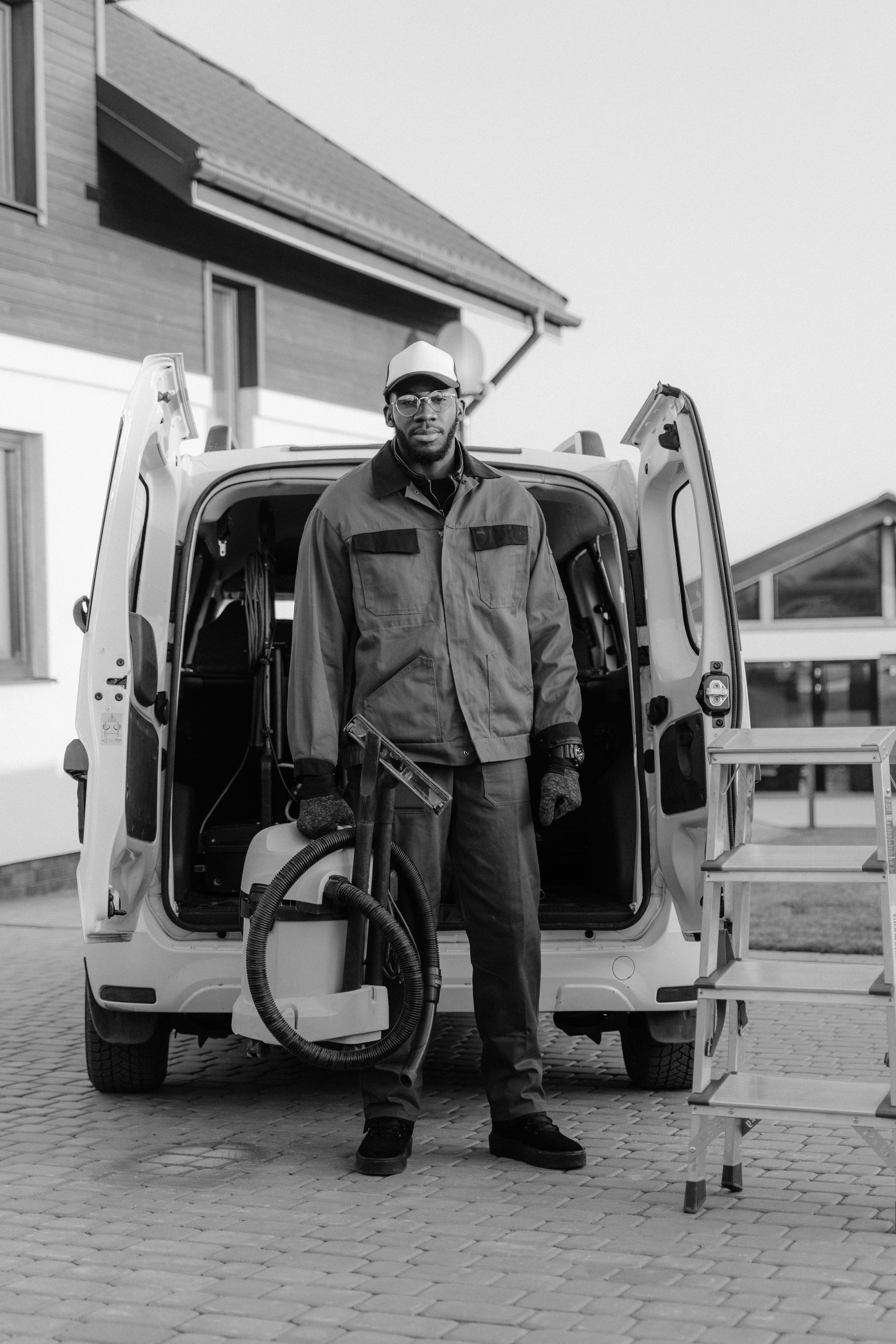 Service technician standing at the back of his van with equipment